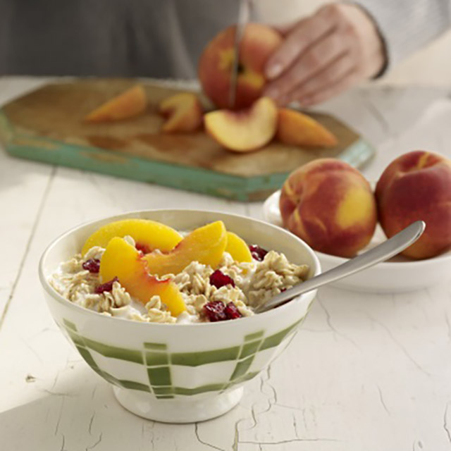 gluten free porridge with sliced apricot and cranberries in a bowl