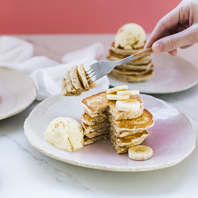 Oat pancakes topped with banana and syrup